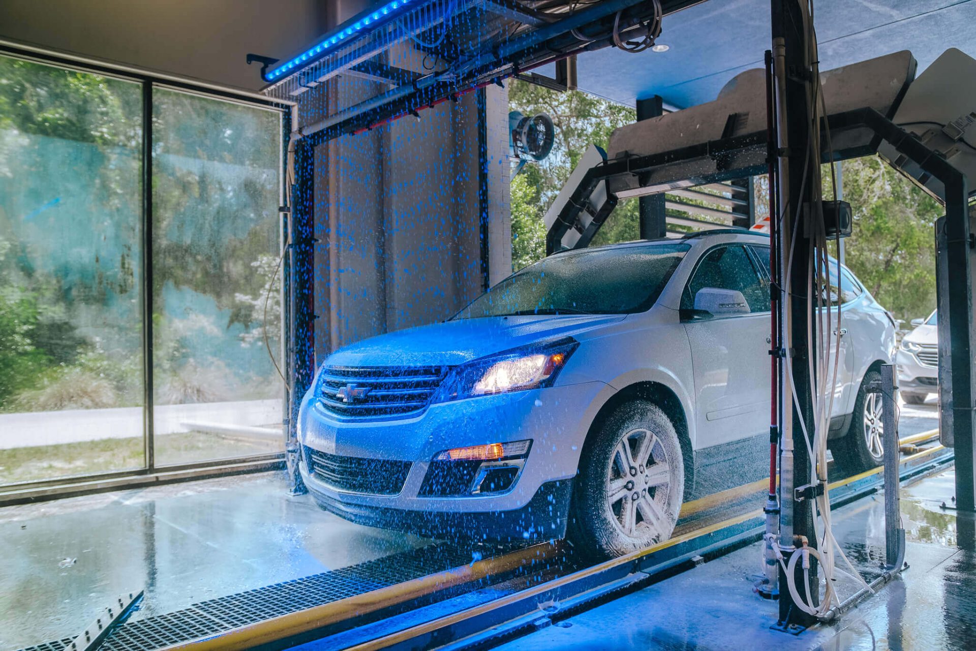 Vehicle receiving careful exterior washing and professional detailing